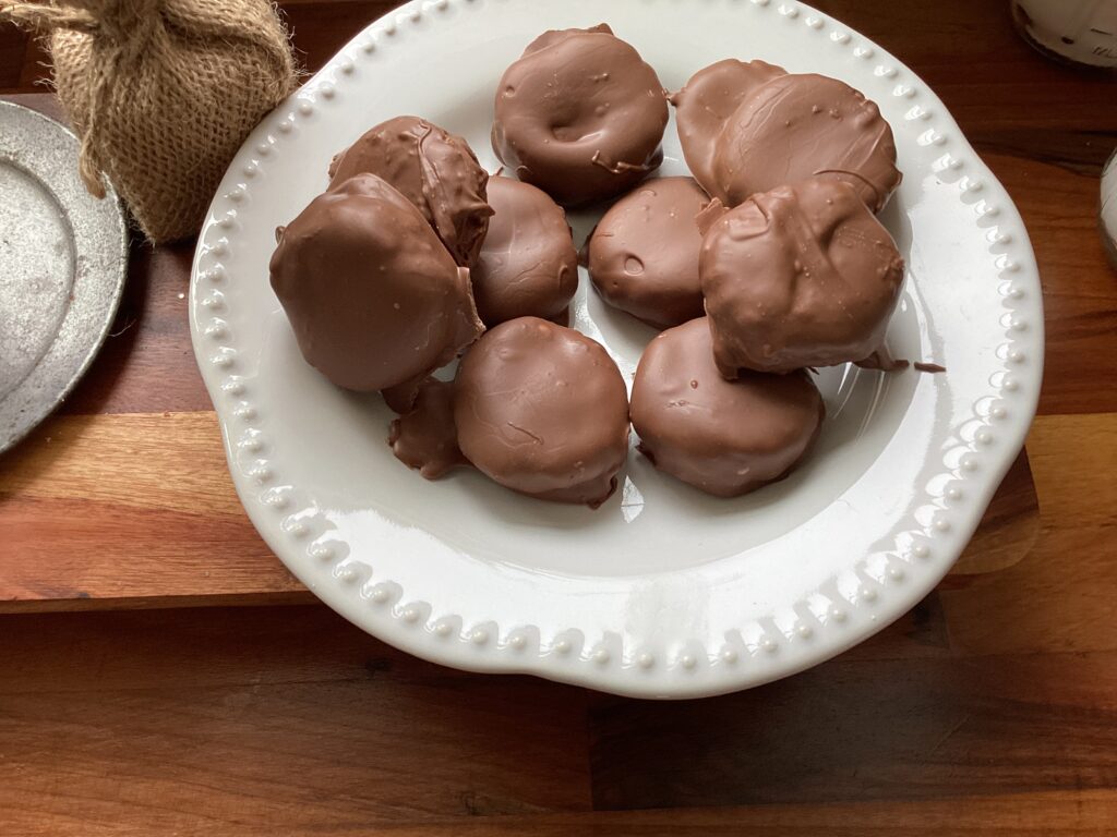 A  white plate of rich and creamy peanut butter cups